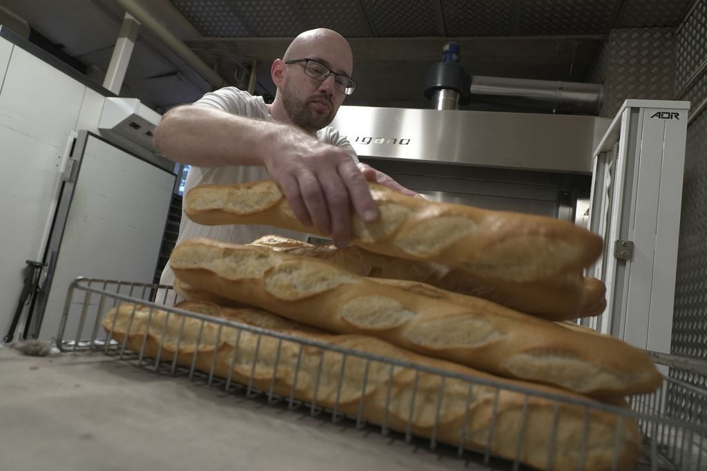Baker Kevin Luce makes bread in Saint-Just-en-Chaussee, France, Thursday Sept. 24, 2026. (AP Photo/John Leicester)
