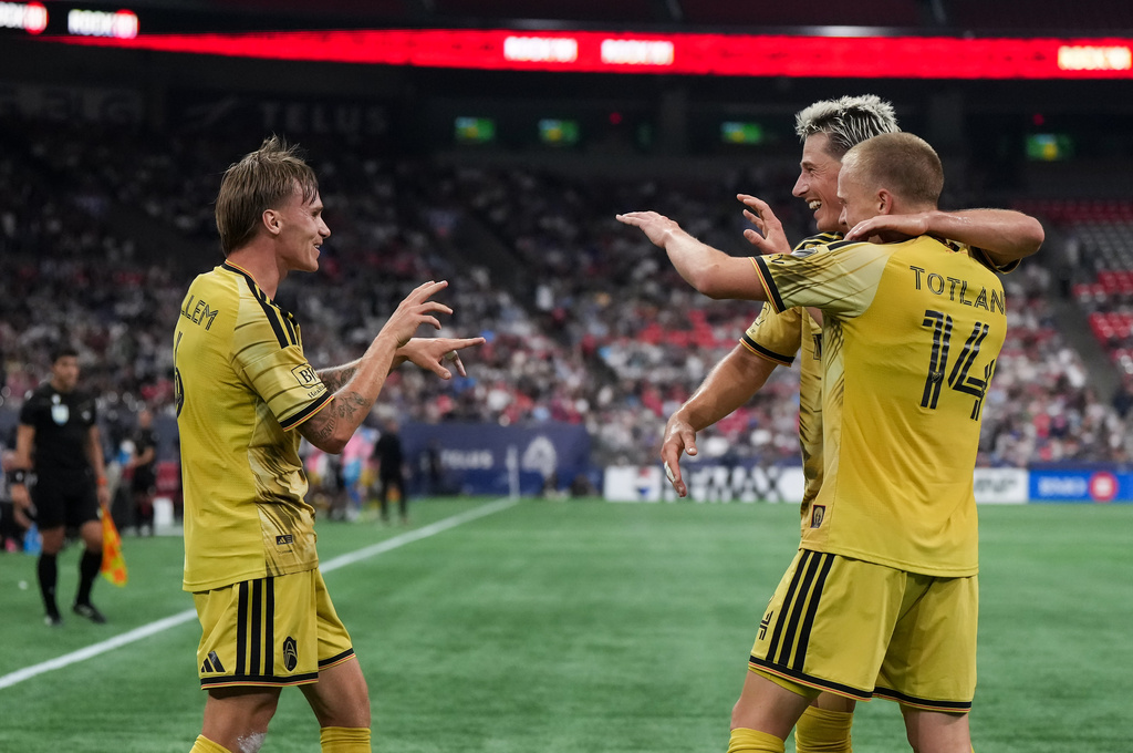 St. Louis City's Conrad Wallem, left, Lukas MacNaughton, back right, and Tomas Totland, front right, celebrate Wallem's goal during the first half of a soccer match against the Vancouver Whitecaps, in Vancouver, Saturday, Sept. 5, 2026. (Darryl Dyck/The Canadian Press via AP)