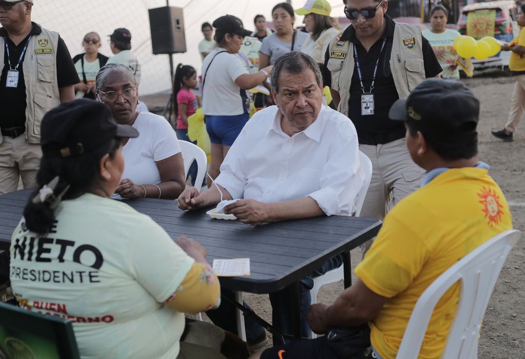 FILE - Presidential candidate Jorge Nieto of the Good Government party talks with a group of supporters during a campaign rally in Lima, Peru, April 8, 2026. (AP Photo/Gerardo Marin, File)