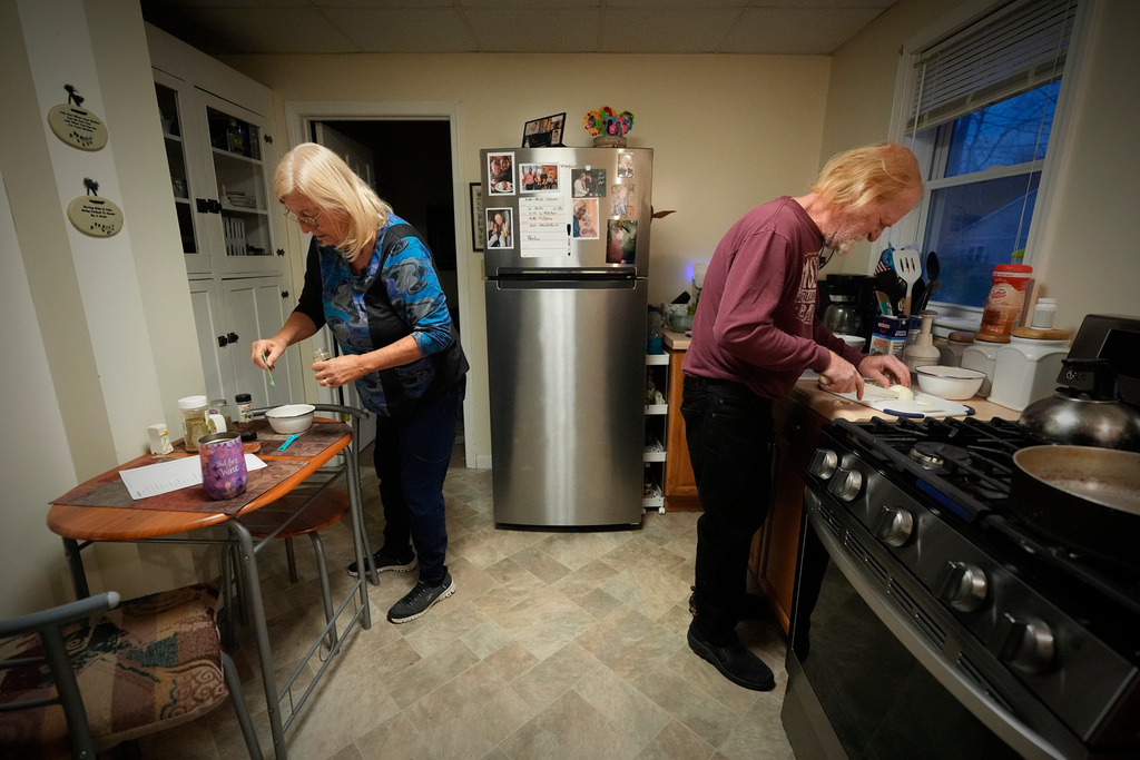 Marsha, left, and Kirk Luce, both patients at Ammonoosuc Community Health Services, prepare dinner, Thursday, Oct. 23, 2025, at their home in Franconia, N.H. (AP Photo/Robert F. Bukaty)