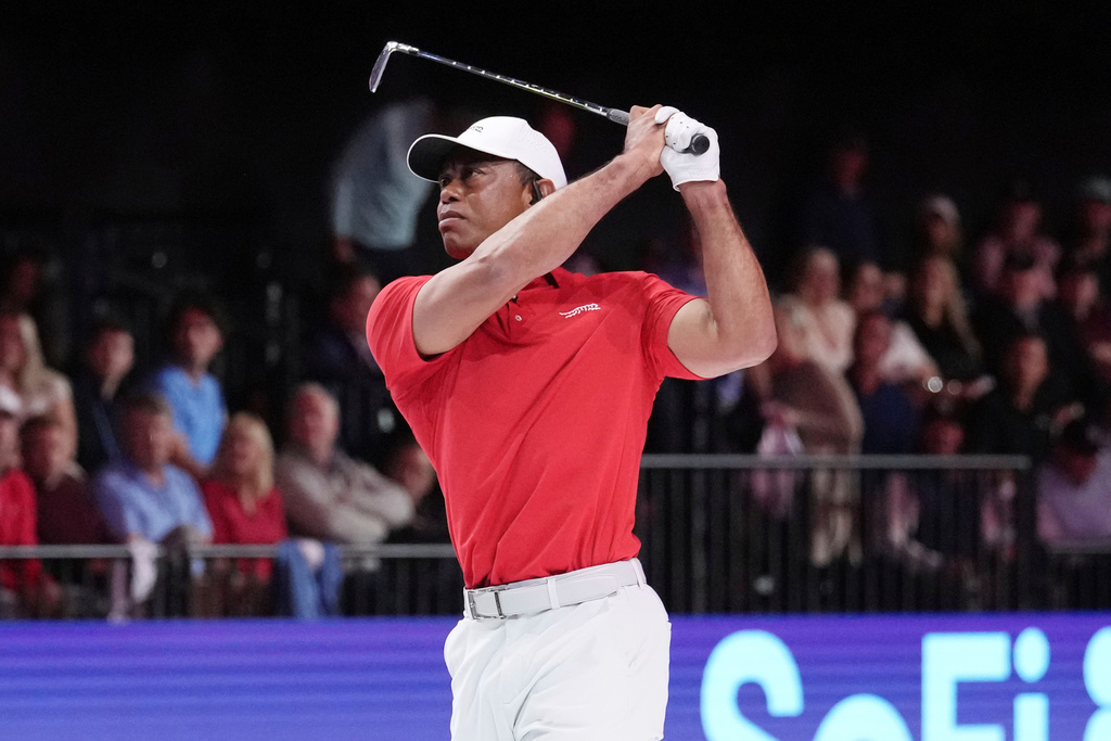 FILE - Tiger Woods of the Jupiter Links Golf Club tees off from the 12th hole during a match against the Los Angeles Golf Club, Jan. 14, 2025, in Palm Beach Gardens, Fla. (AP Photo/Marta Lavandier, File)