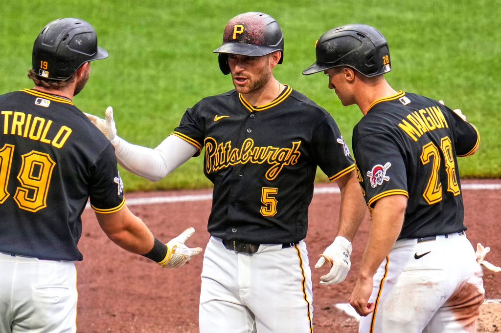Pittsburgh Pirates' Brandon Lowe (5) celebrates with Jared Triolo (19) and Jake Mangum (28) after they all scored on his three-run home run off Cincinnati Reds pitcher Chase Burns during the third inning of a baseball game in Pittsburgh, Saturday, June 27, 2026. (AP Photo/Gene J. Puskar)