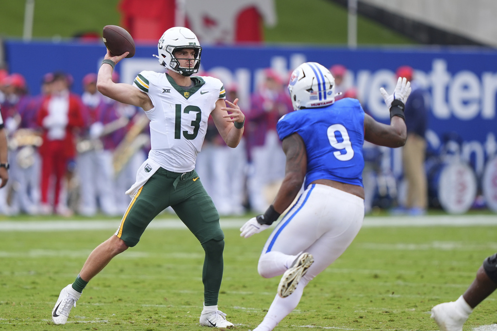 Baylor quarterback Sawyer Robertson (13) passes as SMU defensive end Cameron Robertson (9) rushes in during the first half of an NCAA college football game Saturday, Sept. 6, 2025, in Dallas. (AP Photo/LM Otero)