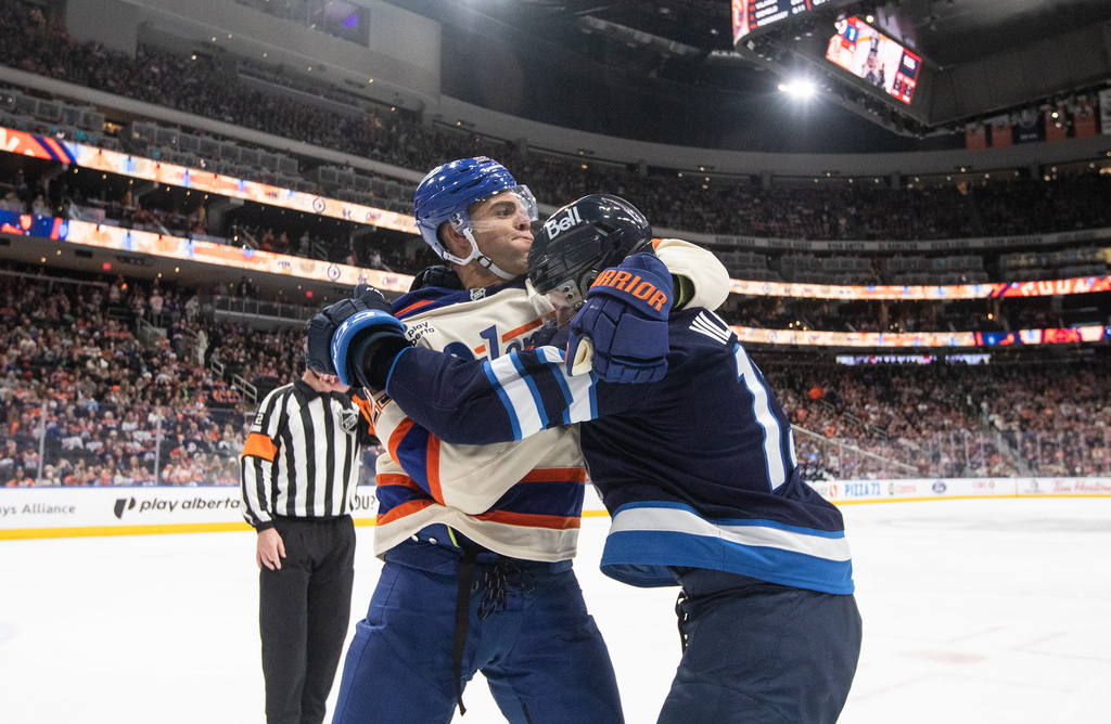 Winnipeg Jets' Gabriel Vilardi (13) and Edmonton Oilers' Darnell Nurse (25) rough it up during third period NHL action, in Edmonton on Saturday, Dec. 6, 2025. (Jason Franson/The Canadian Press via AP)