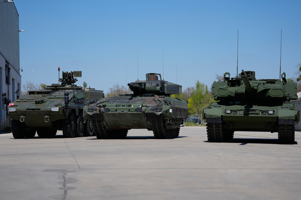FILE - A boxer armoured personnel carrier, from left, a Puma infantry fighting vehicle and a Leopard battle tank are displayed during the opening of a new production line production line of Boxer 8x8 wheeled armoured personnel carrier produced by pan-European defense company KNDS in Munich, Germany, on April 22, 2026. (AP Photo/Matthias Schrader, File)