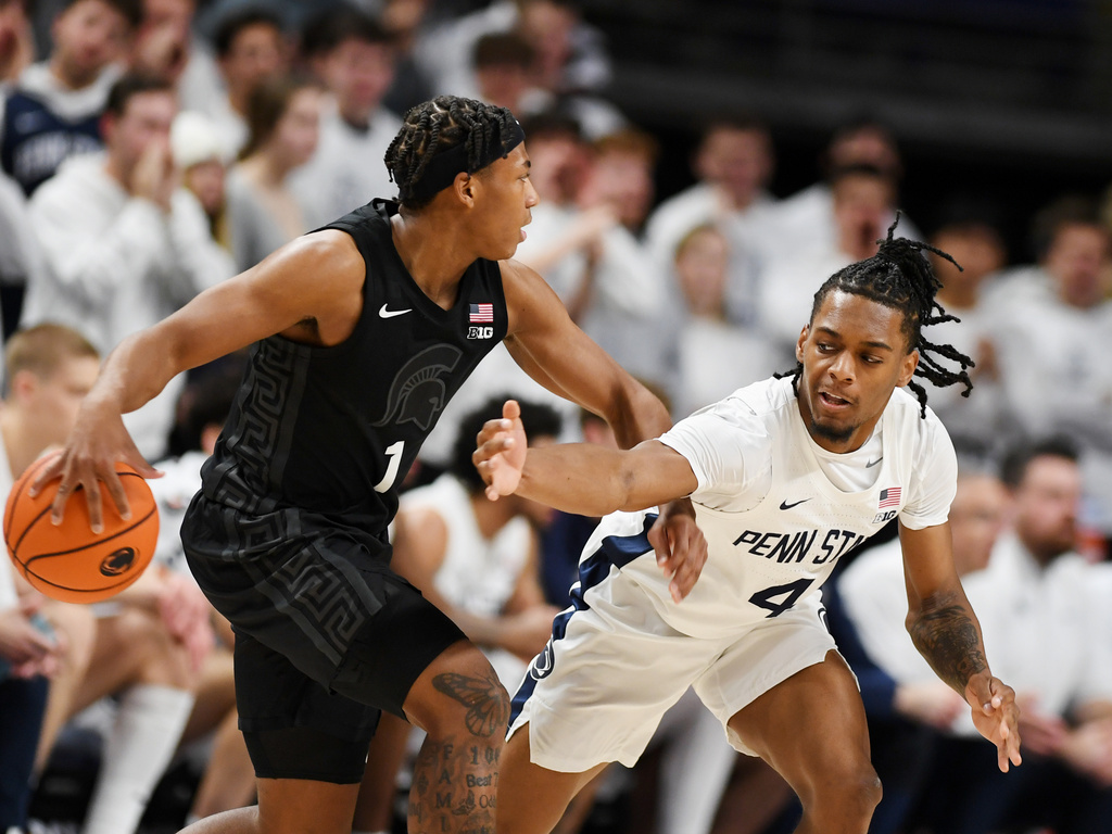Penn State's Kayden Mingo (4) attempt to knock the ball away from Michigan State's Jeremy Fears Jr (1) during the first half of an NCAA college basketball game Saturday, Dec. 13, 2025, in State College, Pa. (AP Photo/Gary M. Baranec)