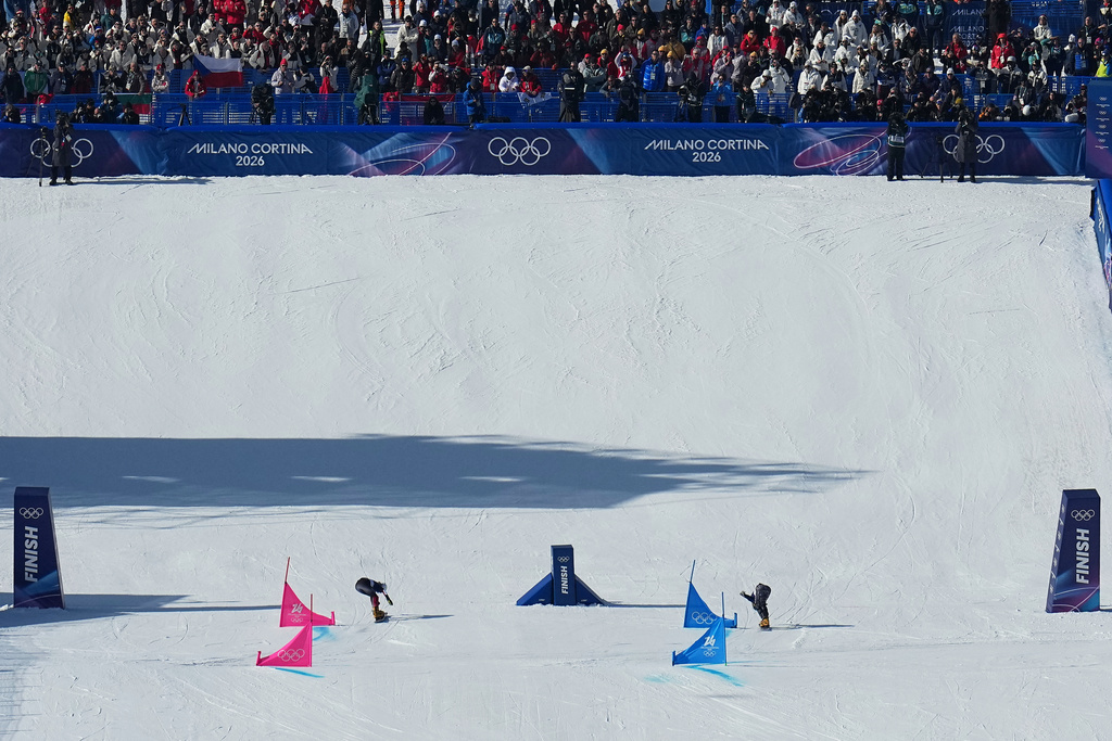Austria's Sabine Payer, left, beats out Czechia's Ester Ledecka during the women's snowboarding parallel giant slalom finals at the 2026 Winter Olympics, in Livigno, Italy, Sunday, Feb. 8, 2026. (AP Photo/Gregory Bull)