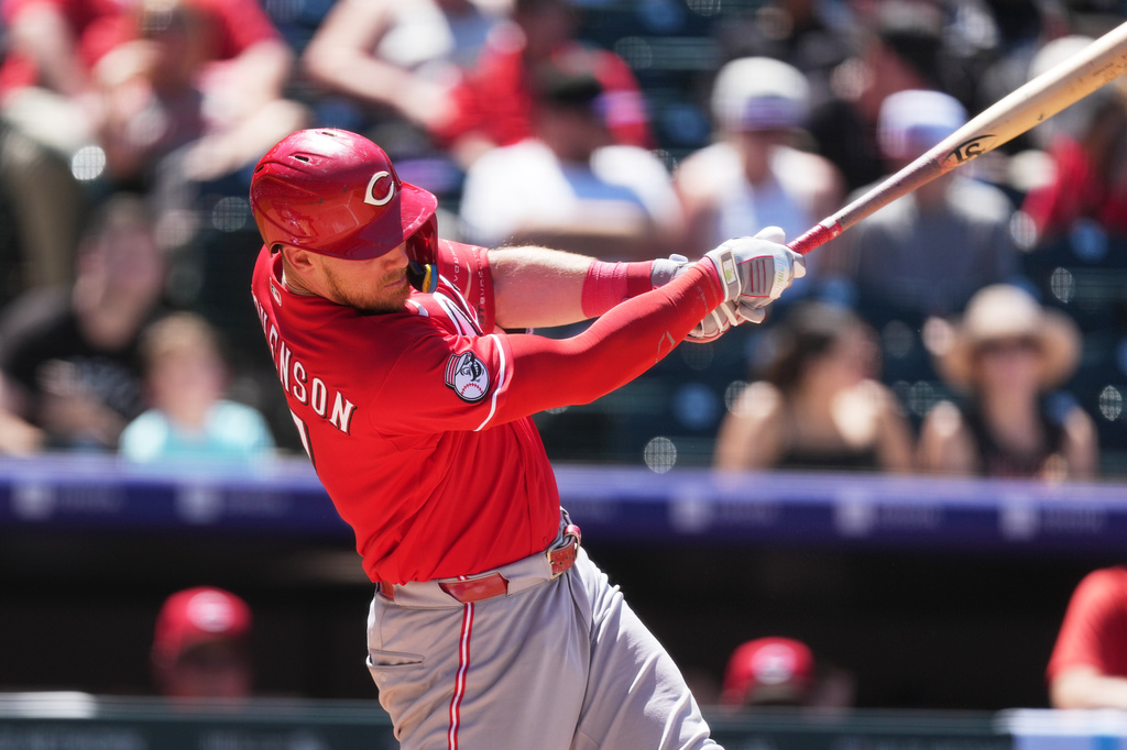 Cincinnati Reds' Tyler Stephenson follows through with his swing after connecting for a solo home run off Colorado Rockies pitcher Tanner Gordon in the fifth inning of a baseball game Sunday, July 19, 2026, in Denver. (AP Photo/David Zalubowski)