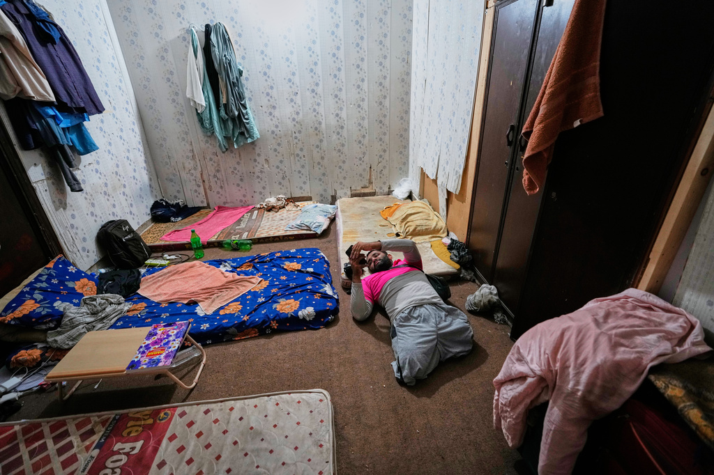 Hamza Ali, 28, who lost both legs in a road accident, rests before leaving for work in Islamabad, Pakistan, Friday, July 17, 2026. (AP Photo/Anjum Naveed)