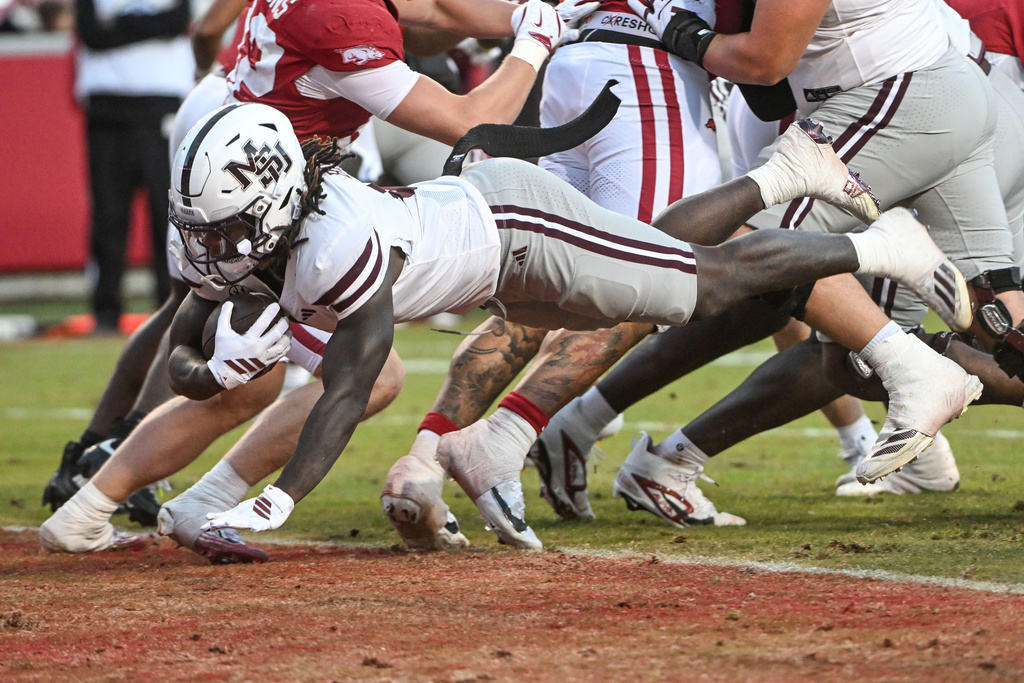 Mississippi State running back Davon Booth (6) dives into the end zone to score a touchdown against Arkansas during the second half of an NCAA college football game Saturday, Nov. 1, 2025, in Fayetteville, Ark. (AP Photo/Michael Woods)