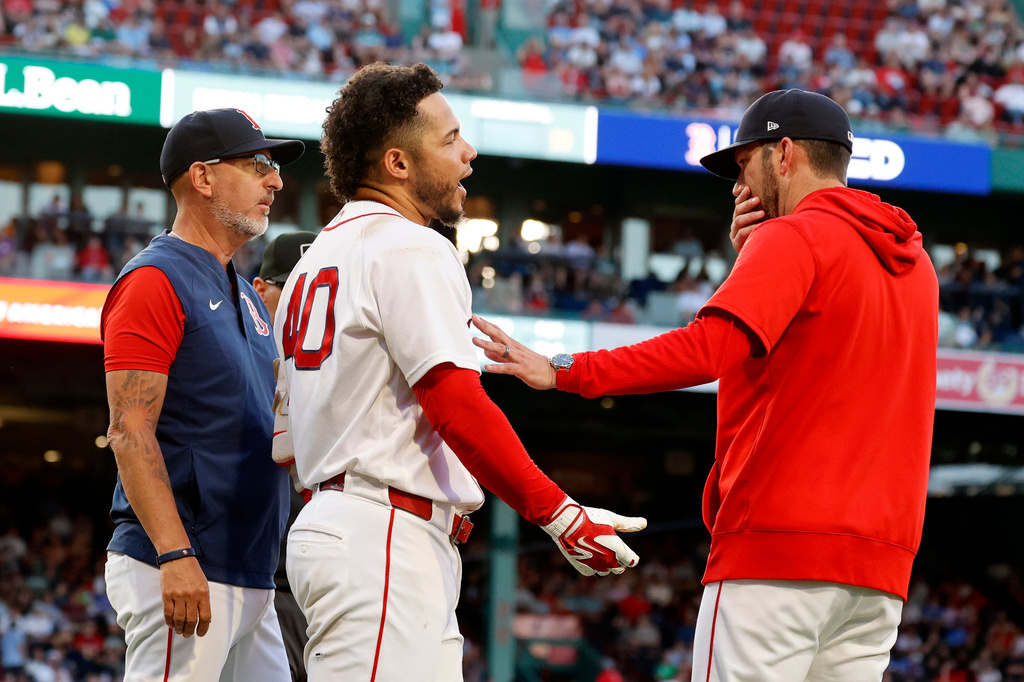 Boston Red Sox interim manager Chad Tracy, right, holds back Willson Contreras, center, after Contreras was thrown out for contesting a call during the second inning of a baseball game against the Washington Nationals, Monday, June 29, 2026, in Boston. (AP Photo/Mary Schwalm)
