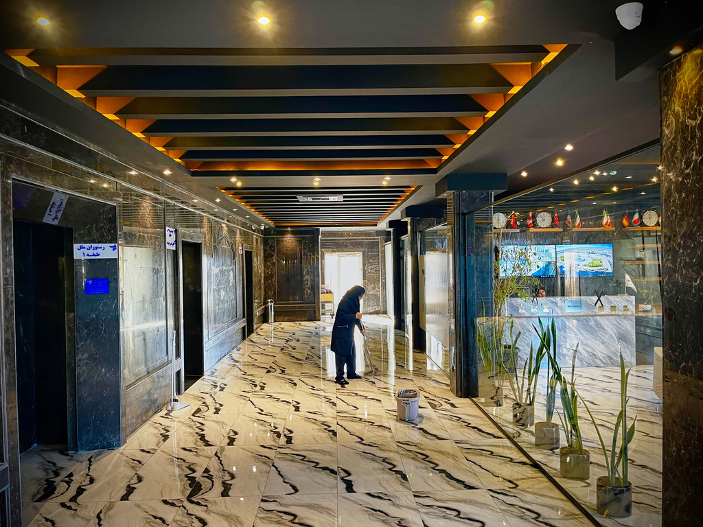 A woman cleans the floor in a roadside hotel on Road 2 near Golshahr, Iran, Thursday, April 9, 2026. (AP Photo/Francisco Seco)