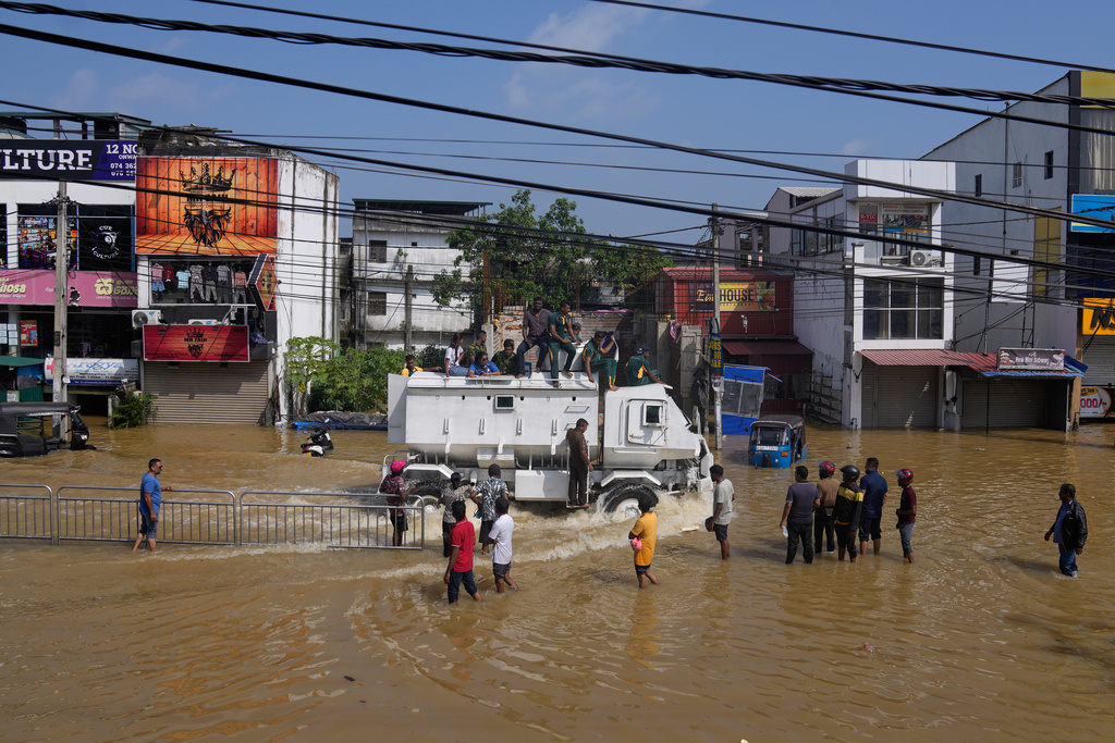 A military vehicle carries flood victims through a submerged area to safety in Colombo, Sri Lanka, Sunday, Nov. 30, 2025. (AP Photo/Eranga Jayawardena)