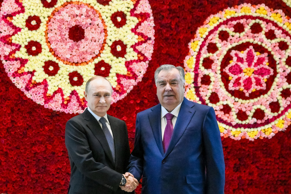 Russian President Vladimir Putin, left, and Tajik President Emomali Rahmon shake hands during their meeting in Dushanbe, Tajikistan, Wednesday, Oct. 8, 2025. (Grigory Sysoyev, Sputnik, Kremlin Pool Photo via AP)