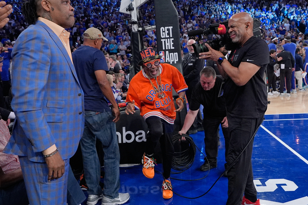 Spike Lee celebrates during a break in the second half of Game 1 in the Eastern Conference finals NBA basketball playoffs series between the New York Knicks and the Cleveland Cavaliers, Tuesday, May 19, 2026, in New York. (AP Photo/Seth Wenig)