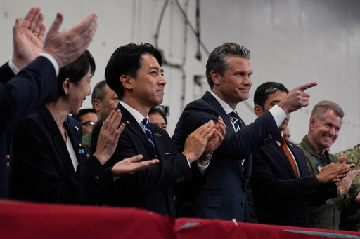 U.S. Defense Secretary Pete Hegseth, center right, with Japanese Prime Minister Sanae Takaichi, left, and Defense Minister Shinjiro Koizumi, gestures as they listen to President Donald Trump speak to members of the military aboard the USS George Washington, an aircraft carrier docked at an American naval base, in Yokosuka, south of Tokyo, Tuesday, Oct. 28, 2025. (AP Photo/Mark Schiefelbein) U.S. Defense Secretary Pete Hegseth, center right, with Japanese Prime Minister Sanae Takaichi, left, and Defense Minister Shinjiro Koizumi, gestures as they listen to President Donald Trump speak to members of the military aboard the USS George Washington, an aircraft carrier docked at an American naval base, in Yokosuka, south of Tokyo, Tuesday, Oct. 28, 2025. (AP Photo/Mark Schiefelbein)