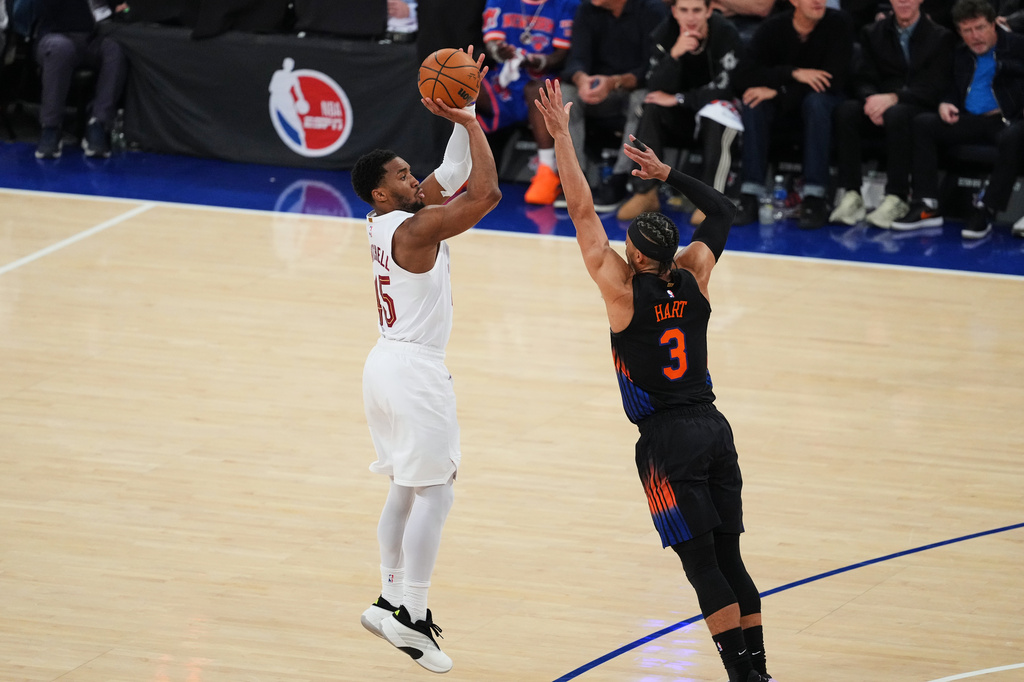 Cleveland Cavaliers' Donovan Mitchell, left, shoots over New York Knicks' Josh Hart (3) during the first half of Game 2 in the Eastern Conference finals NBA basketball playoffs series, Thursday, May 21, 2026, in New York. (AP Photo/Frank Franklin II)
