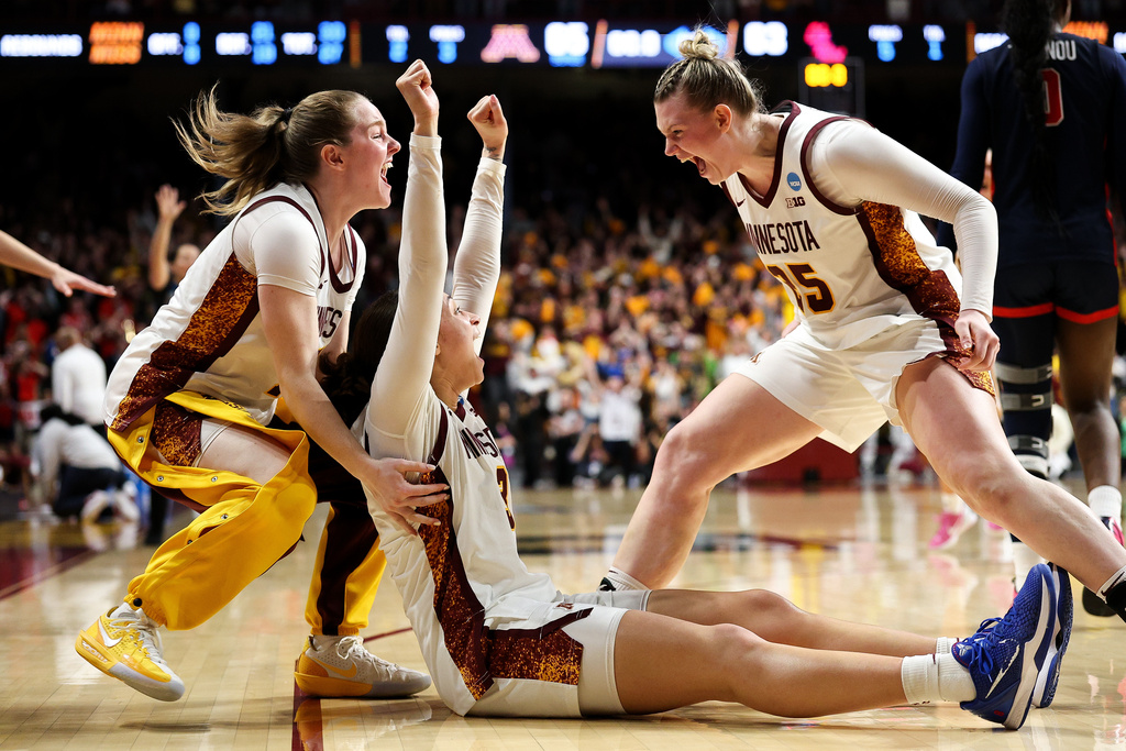 Minnesota guard Amaya Battle, center, celebrates after her winning basket against Mississippi during the second half in the second round of the NCAA college basketball tournament, Sunday, March 22, 2026, in Minneapolis. (AP Photo/Matt Krohn)