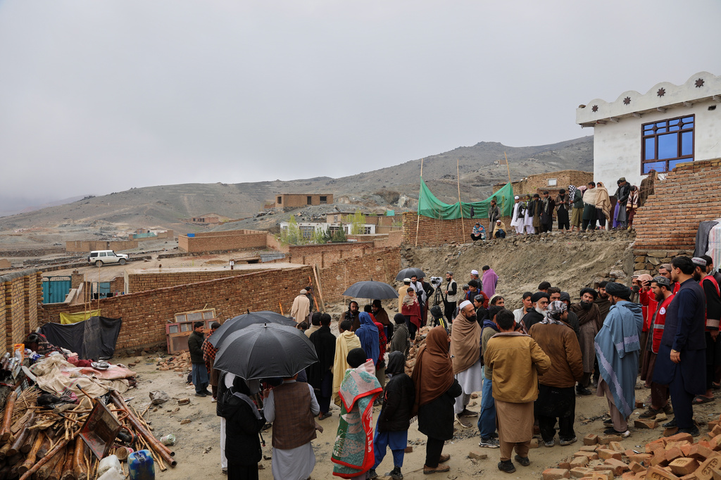 Locals and journalists inspect a house damaged by an earthquake in the village of Ittefaq, on the outskirts of Kabul, Afghanistan, Saturday, April 4, 2026. (AP Photo/Siddiqullah Alizai)
