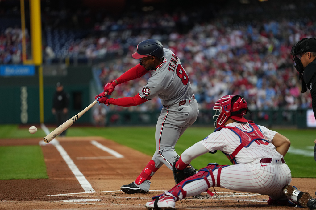 Washington Nationals' José Tena hits an RBI single off of Philadelphia Phillies pitcher Taijuan Walker during the first inning of a baseball game, Monday, March 30, 2026, in Philadelphia. (AP Photo/Matt Rourke)