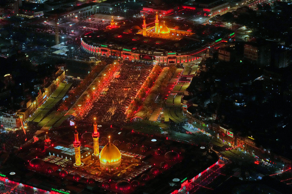 Aerial photo shows Shiite pilgrims gathering between the holy shrine of Imam Hussein and the holy shrine of Imam Abbas ahead of Arbaeen, the annual Shiite commemoration marking 40 days after Ashura, in Karbala, Iraq, Sunday, Aug. 2, 2026. (AP Photo/Hadi Mizban)