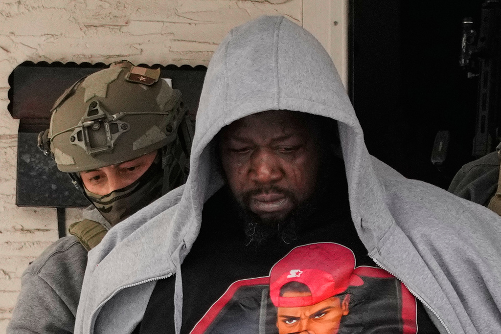 ADDS IDENTIFICATION: Garrison Gibson becomes emotional as he is arrested by federal immigration officers Sunday, Jan. 11, 2026, in Minneapolis. (AP Photo/John Locher)