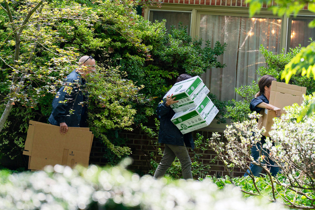 FBI agents carry empty boxes to former national security adviser John Bolton's house, Friday, August. 22, 2025, in Bethesda, Md. (AP Photo/Jose Luis Magana)