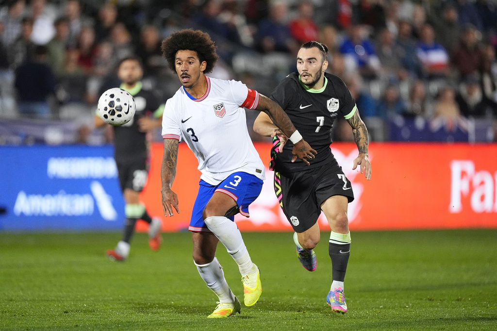FILE - United States defender Chris Richards, front, pursues the ball with Australia forward Nicholas D'Agostino in the second half of an international friendly soccer match Tuesday, Oct. 14, 2025, in Commerce City, Colo.(AP Photo/David Zalubowski, File)