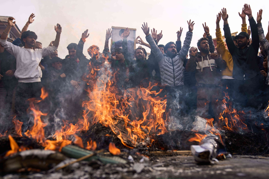 Shiite Muslims shout slogans as they burn effigies of President Donald Trump and Israeli Prime Minister Benjamin Netanyahu during a protest against the killing of Iran's Supreme Leader Ayatollah Ali Khamenei, in Budgam, northeast of Srinagar, Indian controlled Kashmir, Friday, March 6, 2026. (AP Photo/Dar Yasin)