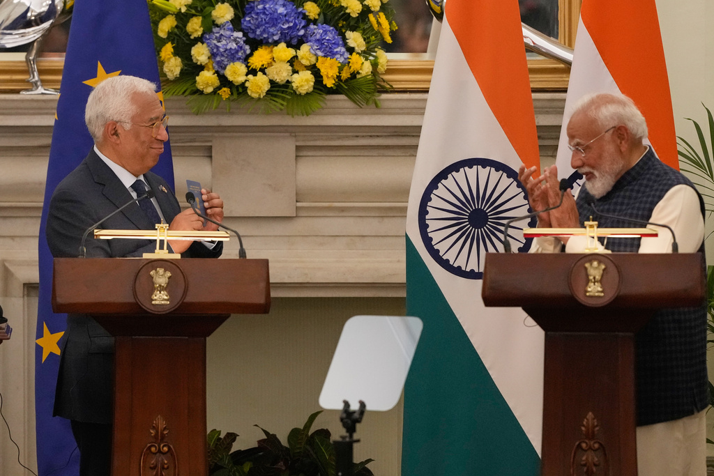 European Council President Antonio Costa, left, shows his Overseas Citizen of India (OCI) card to Indian Prime Minister Narendra Modi, during his press statement after reaching free trade agreement between India and EU in New Delhi, India, Tuesday, Jan. 27, 2026. (AP Photo/Manish Swarup)