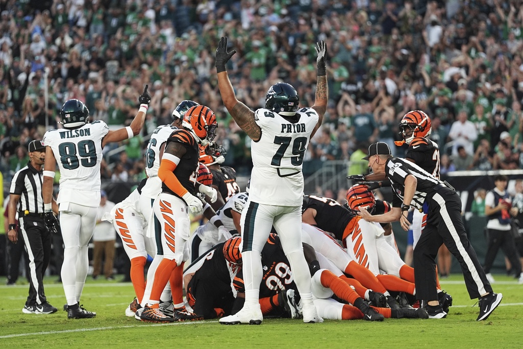 Philadelphia Eagles wide receiver Johnny Wilson (89) and Eagles offensive tackle Matt Pryor (79) celebrate a touchdown by teammate quarterback Tanner McKee (16) during the first half of an NFL preseason football game against the Cincinnati Bengals Thursday, Aug. 7, 2025, in Philadelphia. (AP Photo/Matt Rourke)