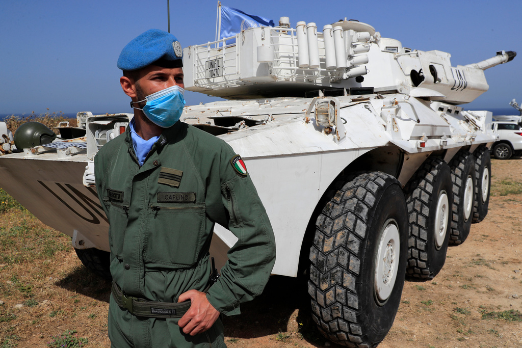 FILE - An Italian U.N. peacekeeper soldier stands guard at a road that links to a United Nations Interim Force In Lebanon, or UNIFIL base, in Naqoura town, Lebanon, on May 4, 2021. (AP Photo/Hussein Malla, File)
