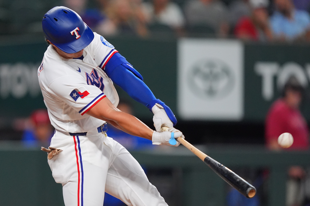 Texas Rangers' Justin Foscue launches a solo home run during the second inning of a baseball game against the Washington Nationals, Tuesday, Aug. 18, 2026, in Arlington, Texas. (AP Photo/LM Otero)