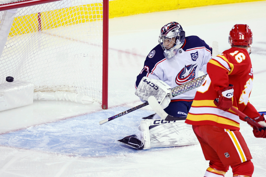 Columbus Blue Jackets goalie Jet Greaves is scored on by Calgary Flames Morgan Frost during first period NHL hockey action in Calgary on Wednesday, Nov. 5, 2025. (Larry MacDougal/The Canadian Press via AP)