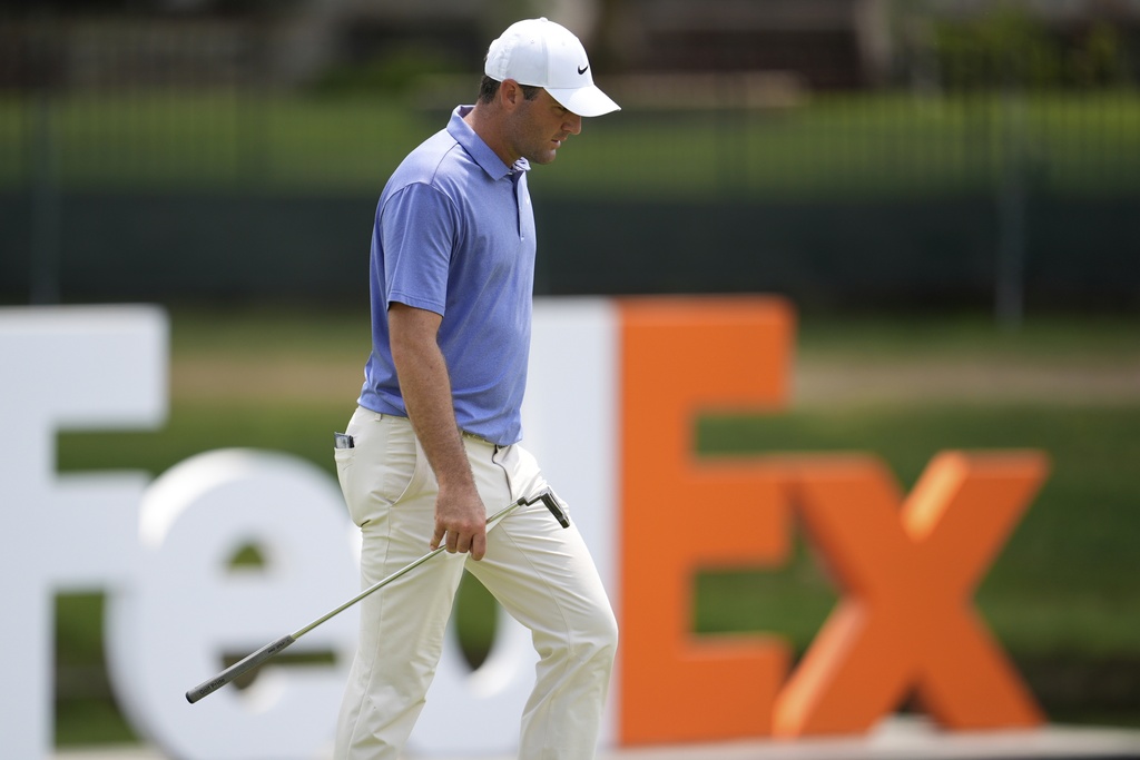 Scottie Scheffler walks to the 18th green during the second round of the St. Jude Championship golf tournament Friday, Aug. 8, 2025, in Memphis, Tenn. (AP Photo/George Walker IV)