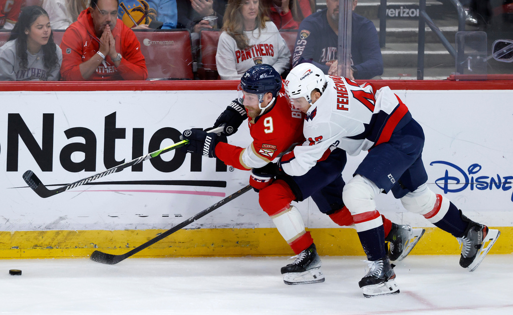 Florida Panthers center Sam Bennett (9)and Washington Capitals defenseman Martin Fehérváry (42) fight for the puck during the second period of an NHL hockey game, Monday, Dec. 29, 2025, in Sunrise, Fla. (AP Photo/Rhona Wise)