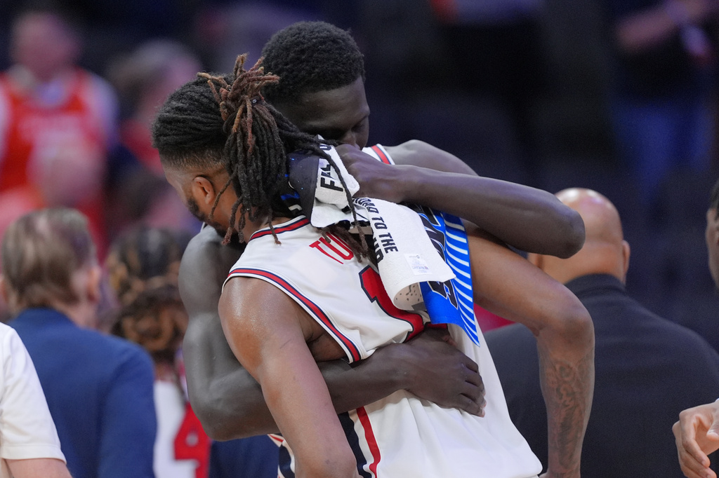 Houston forward Joseph Tugler (11) is embraced by a teammate Kalifa Sakho after losing to Illinois in the Sweet 16 of the NCAA college basketball tournament Friday, March 27, 2026, in Houston. (AP Photo/Eric Gay)