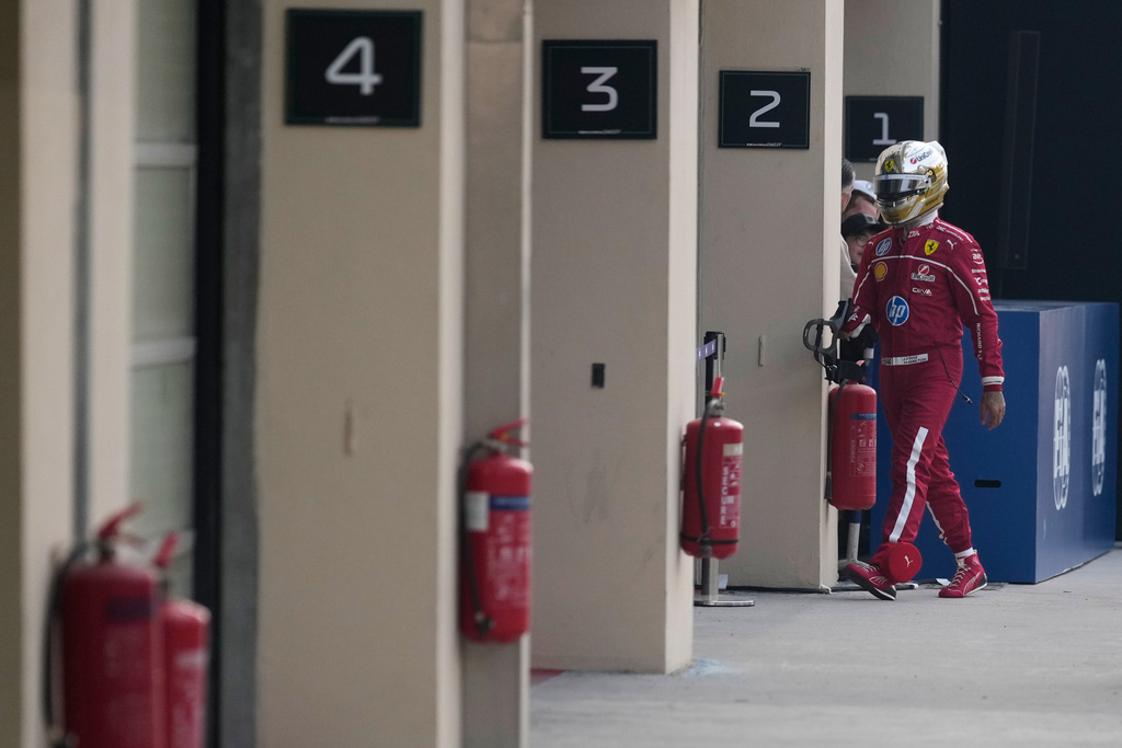 Ferrari driver Lewis Hamilton of Britain walks back to his pits after he crashed into the track wall during the third practice ahead of the Formula One Abu Dhabi Grand Prix at the Yas Marina Circuit in Abu Dhabi, UAE, Saturday, Dec. 6, 2025. (AP Photo/Altaf Qadri)
