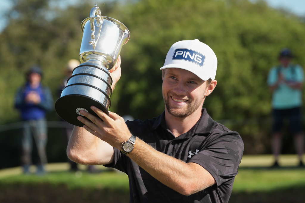 Denmark's Rasmus Neergaard-Petersen holds the Stonehaven Cup after winning the Australian Open golf tournament in Melbourne, Australia, Sunday, Dec. 7, 2025. (AP Photo/Asanka Brendon Ratnayake)