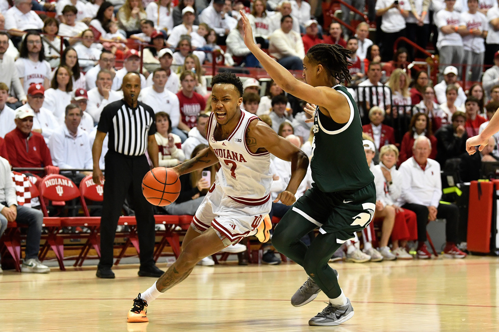 Indiana forward Nick Dorn (7) drives past Michigan State forward Jordan Scott (6) during the second half of an NCAA college basketball game in Bloomington, In., Sunday, March 1, 2026. (AP Photo/Timothy D. Easley)