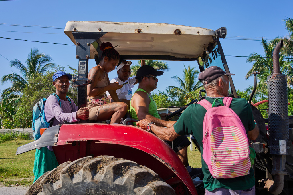 Farmworkers travel in a tractor in Minas, Havana province, Cuba, Monday, April 27, 2026. (AP Photo/Ramon Espinosa)