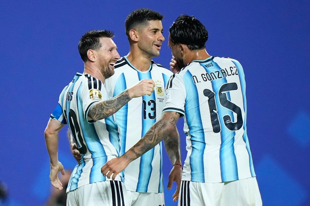 Argentina's Lionel Messi, left, is congratulated by teammates Cristian Romero and Nico Gonzalez, right, after scoring his third goal during the World Cup Group J soccer match between Argentina and Algeria in Kansas City, Mo., Tuesday, June 16, 2026. (AP Photo/Charlie Riedel)