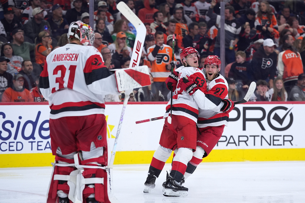 Carolina Hurricanes' Jackson Blake (53), Nikolaj Ehlers (27) and Frederik Andersen (31) celebrate after Blake's game-winning goal in overtime during Game 4 in a second-round NHL hockey Stanley Cup playoff series, Saturday, May 9, 2026, in Philadelphia. (AP Photo/Matt Slocum)