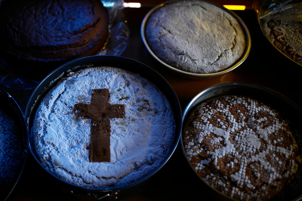 Fanouropites, orange-flavored cakes, are placed on tables to be blessed at the Church of St. Fanourios in Athens, Tuesday, Aug. 25, 2026. (AP Photo/Thanassis Stavrakis)