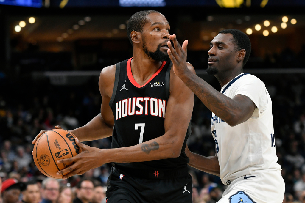 Houston Rockets forward Kevin Durant (7) handles the ball against Memphis Grizzlies guard Vince Williams Jr. (5) in the first half of an NBA basketball game Wednesday, Nov. 5, 2025, in Memphis, Tenn. (AP Photo/Brandon Dill)