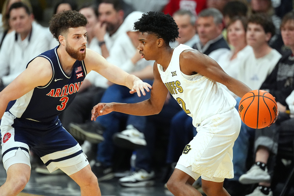 Colorado guard Isaiah Johnson, right, looks to drive to the basket as Arizona guard Anthony Dell'orso defends in the first half of an NCAA college basketball game Saturday, March 7, 2026, in Boulder, Colo. (AP Photo/David Zalubowski)