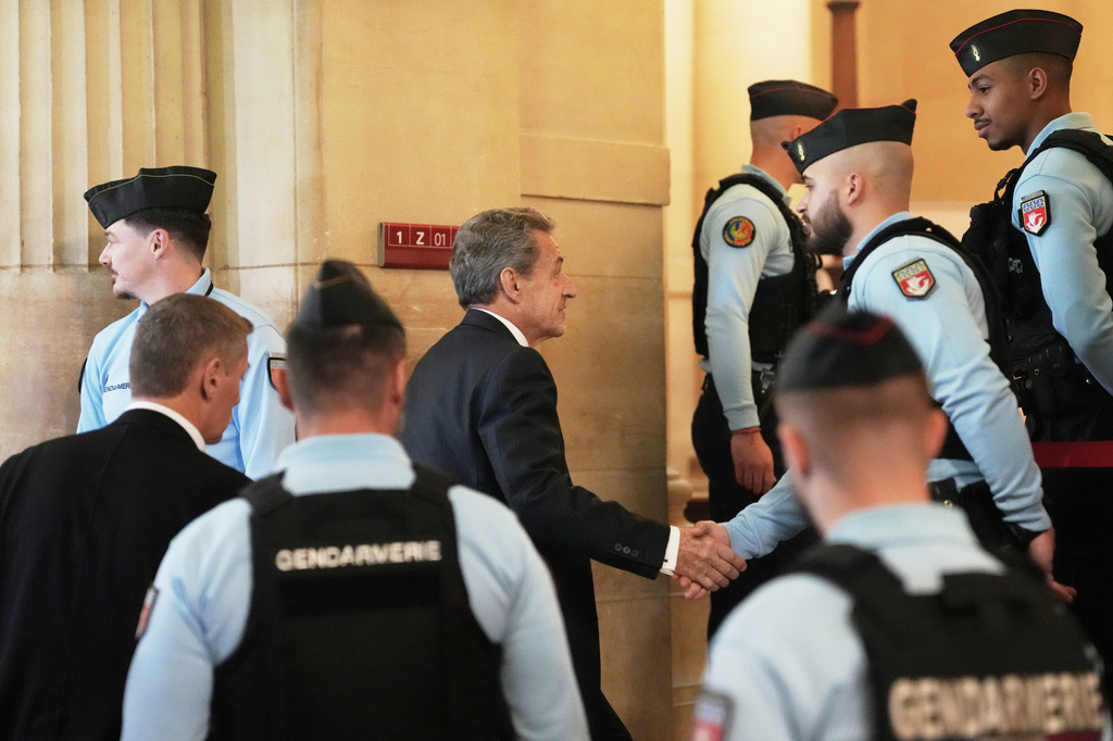 Former French President Nicolas Sarkozy arrives at the appeals courthouse in Paris, France, Tuesday, April 7, 2026, to testify in his trial appealing a conviction involving illegal campaign funds from Libya. (AP Photo/Thibault Camus)