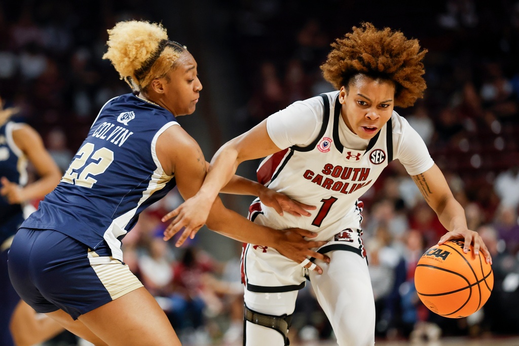 South Carolina guard Maddy McDaniel (1) drives against Queens of Charlotte guard Dayuna Colvin, left, during the first half of an NCAA college basketball game in Columbia, S.C., Sunday, Nov. 23, 2025. (AP Photo/Nell Redmond)
