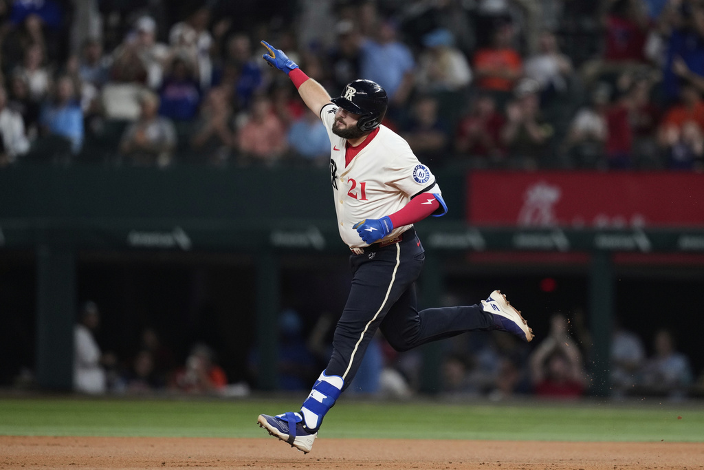 Texas Rangers' Jake Burger celebrates his two-run home run in the third inning of a baseball game against the Houston Astros Friday, Sept. 5, 2025, in Arlington, Texas. (AP Photo/Tony Gutierrez)