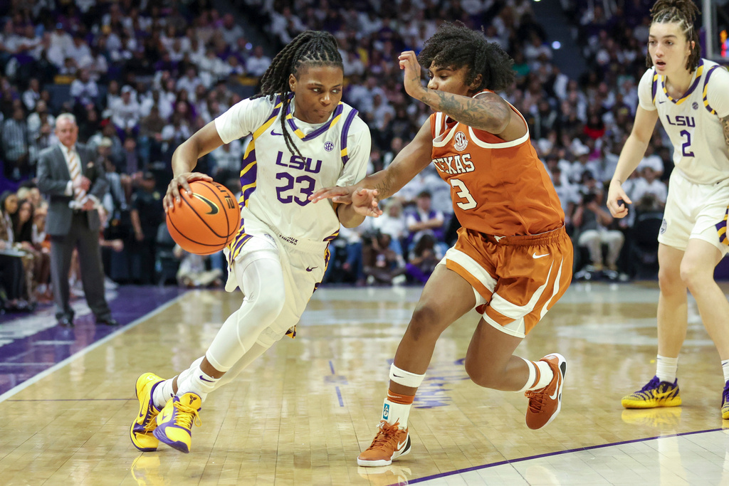 LSU guard MiLaysia Fulwiley (23) tries to make a move against Texas guard Rori Harmon (3) in the second half of an NCAA college basketball game in Baton Rouge, La., Sunday, Jan. 11, 2026. (AP Photo/Peter Forest)